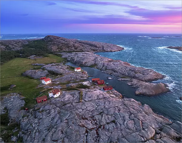 Aerial view of the scenic landscape of granite rocks with isolated houses and red cottages along the shore, Ramsvik island, Bohuslan, Vastra Gotaland, West Sweden, Sweden, Scandinavia, Europe