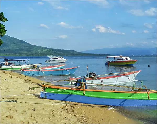 Outrigger canoes and launches at this coral fringed holiday island and scuba diving destination, Bunaken Island, Sulawesi, Indonesia, Southeast Asia, Asia