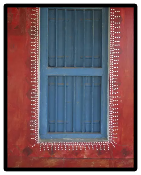 Decorated shuttered window in painted bhunga wall, Dhordo village, Kachchh
