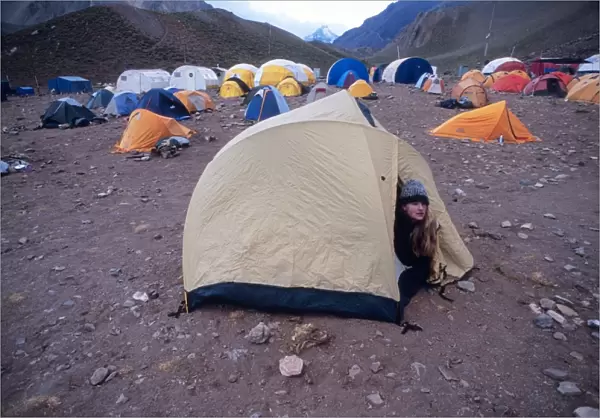 Woman wakes up at Confluencia Base Camp in Aconcagua National Park, Argentina