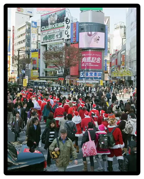 Christmas Santas walking across Shibuya crossing, Shibuya ward, Tokyo, Japan, Asia