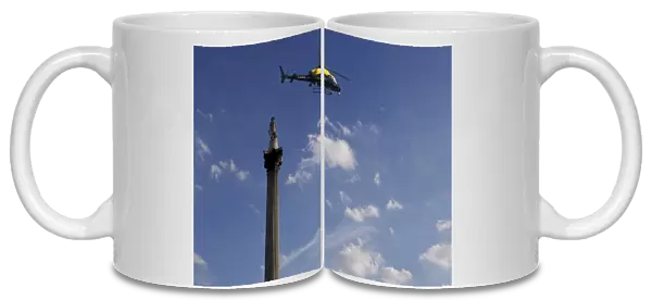 Nelsons Column and police helicopter, London, England, United Kingdom, Europe
