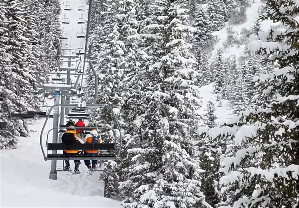 Skiers on a chairlift, Meribel ski resort in the Three Valleys (Les Trois Vallees)