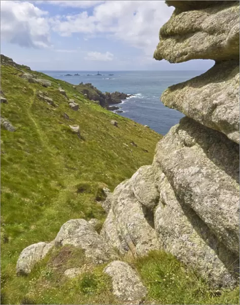 Part of the South West Coast Path at Mayon cliff near Lands End showing the Longships lighthouse in the distance, Cornwall, England, United
