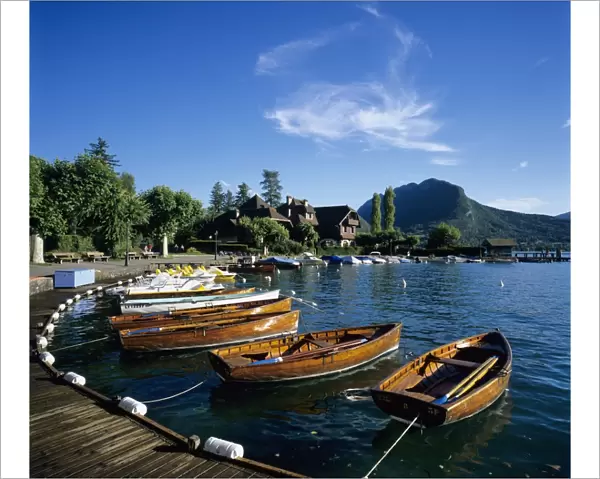 Rowing boats along lake shore, Talloires, Lake Annecy, Rhone Alpes, France, Europe