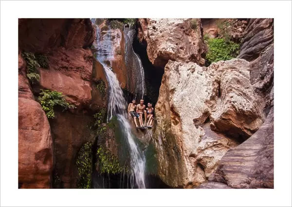 Tourists bathing in a waterfall, seen while rafting down the Colorado River, Grand Canyon, Arizona, United States of America, North America