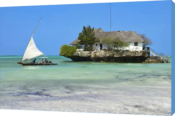 Tourist on a traditional Dhow boat, The Rock Restaurant, Bwejuu Beach, Zanzibar, Tanzania, Indian Ocean, East Africa, Africa