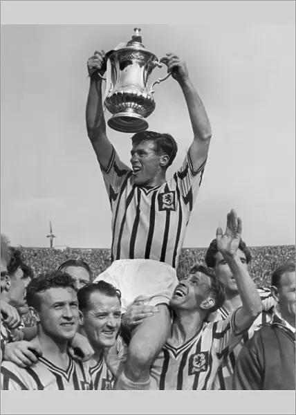 Aston Villa captain Johnny Dixon lifts the FA Cup in 1957