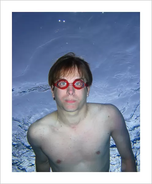 Man swimming underwater wearing goggles