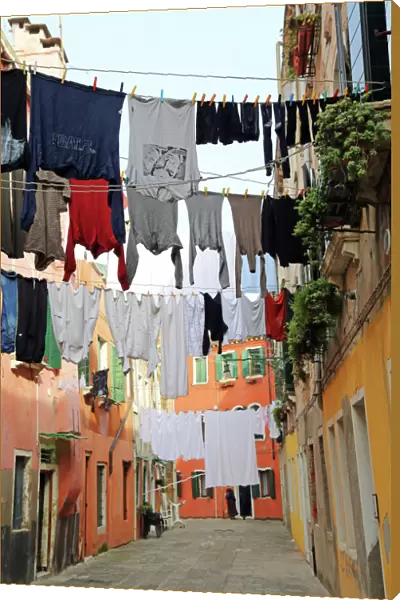 Clothes hanging on a washing line across a street on washday in Venice, Italy