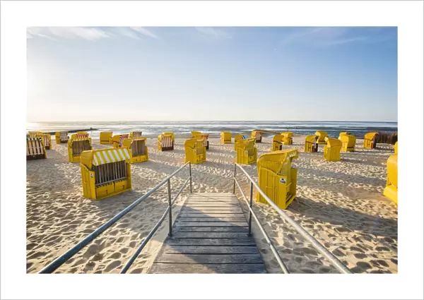 Duhnen, Cuxhaven, Lower Saxony, Germany. Yellow Strandkorbs along the beach