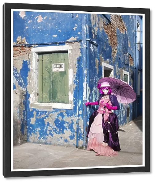 Woman in pink costume holding umbrella during Carnival, Island of Burano, Venice