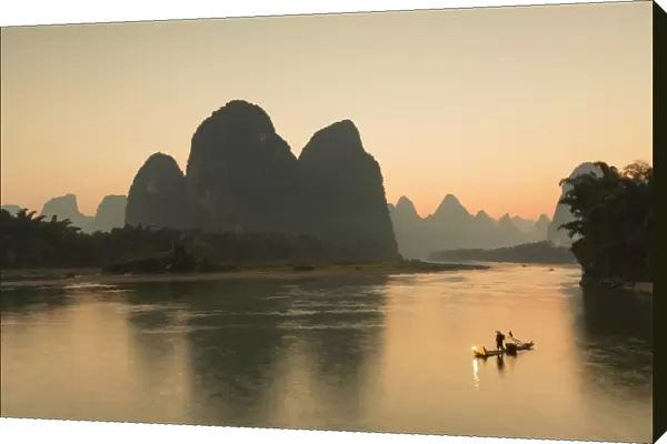 Cormorant fisherman on Li River at dusk, Xingping, Yangshuo, Guangxi, China