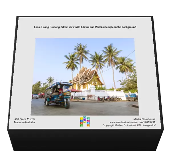 Laos, Luang Prabang. Street view with tuk tuk and Wat Mai temple in the background