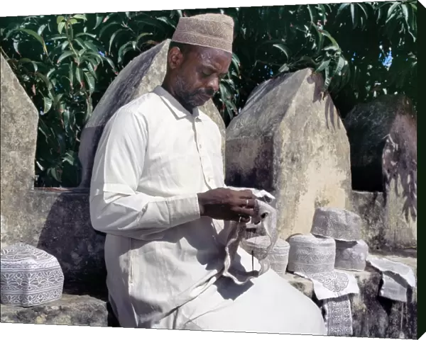 A man embroiders Swahili hats