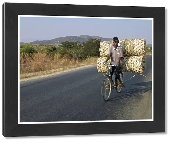 A cyclist taking baskets to market