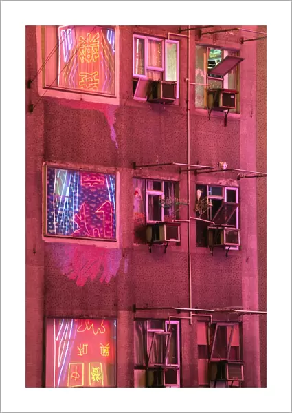 The neon lights of Kowloon reflected in the windows