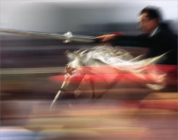 A rider on horseback speeds through the crowd attempting