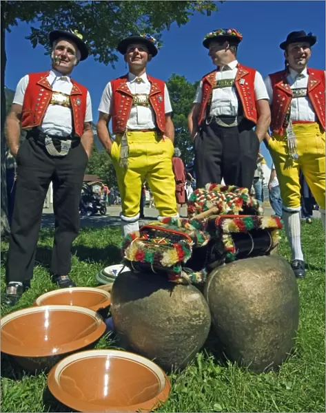 Cowbell ringers in traditional alpine costume at the