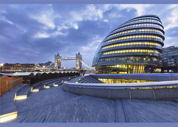 Illuminated Tower Bridge, City Hall, right, designed by Norman Foster, at dawn, London