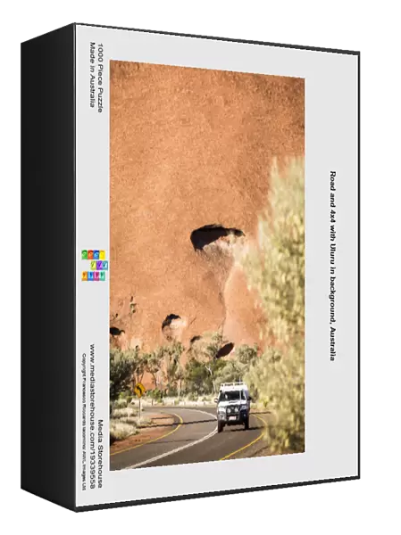 Road and 4x4 with Uluru in background, Australia