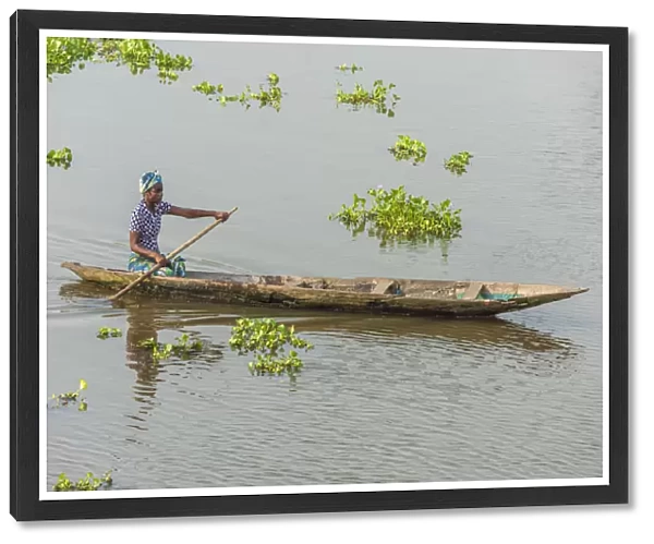Africa, Benin, Lake Nokoua. A woman in her traditional wooden boat in the famous