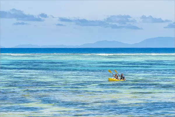 Tourists canoeing in la Digue, Seychelles, Africa