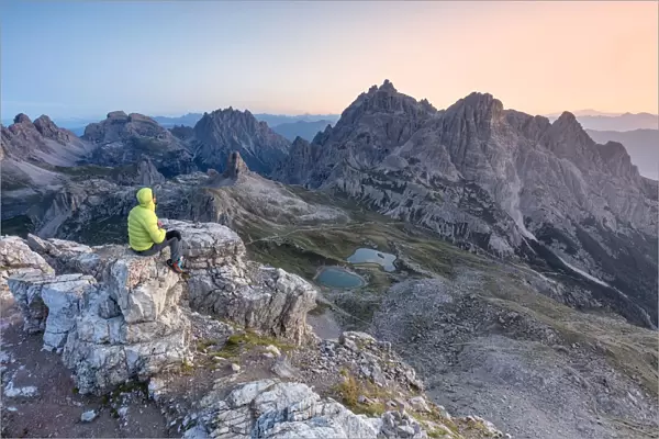Hiker on the top of mount Paterno  /  Paternkofel looking the sunrise, Sexten Dolomites