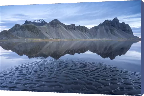 The mountains reflect on the surface of the ocean. Stokksnes, Eastern Iceland, Europe