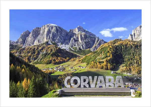 The colorful woods frame the village of Corvara and the high peaks at Badia Valley
