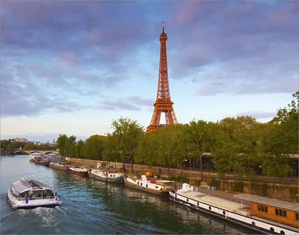 France, Paris, Eiffel Tower and tourist boat on River Seine