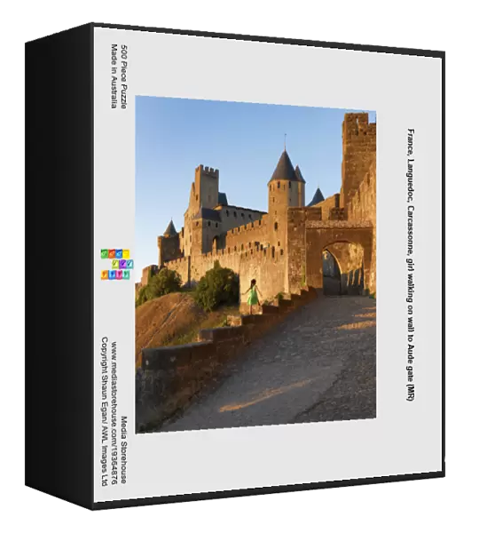 France, Languedoc, Carcassonne, girl walking on wall to Aude gate (MR)