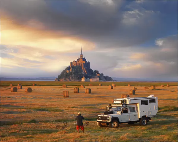 France, Normandy, Le Mont Saint Michel, Man and truck in hay field