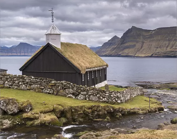 Traditional grass roofed Faroese church in the village of Funningur on the island