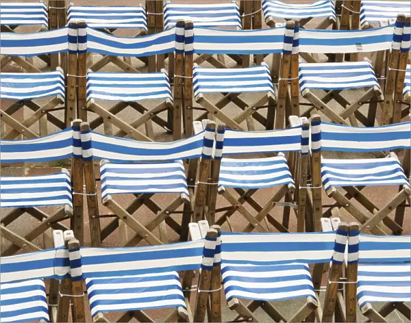 Rows of traditional blue and white deckchairs, Eastbourne, Sussex, UK