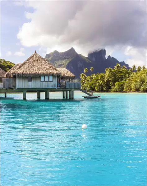 Water bungalows of Hilton resort in the lagoon of Bora Bora, French Polynesia