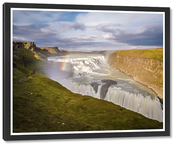 Iceland, Gullfoss at sunset, rainbow and water steam, icelandic landscape