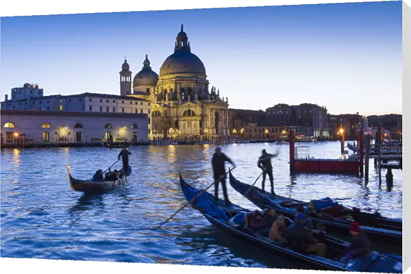 Gondolas and Santa Maria della Salute at dusk. Venice, Veneto, Italy