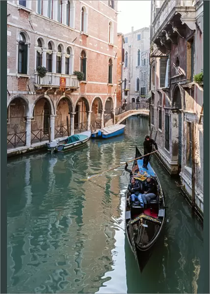 Typical gondola in a canal at daytime, Venice, Italy