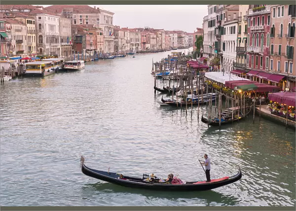 Venice, Veneto, Italy. Buildings and gondola from Rialto Bridge