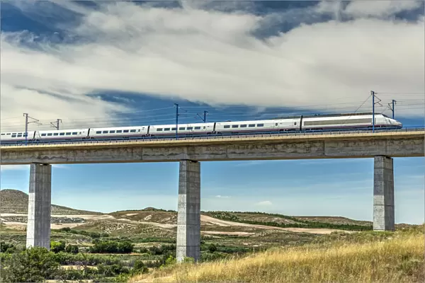 The Madrid-Barcelona AVE high-speed passenger train while is crossing a viaduct, Fuentes