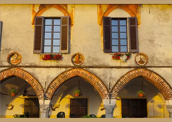 Old Town Building Facade illuminated at sunrise, Arona, Lake Maggiore, Piedmont, Italy