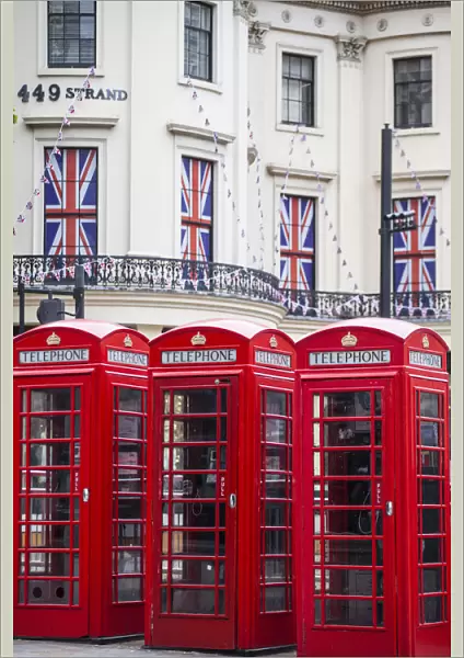 UK, England, London, The Strand, Red telephone box and Union Jack bunting to celebrate