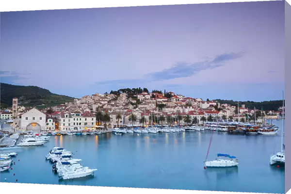 Elevated view over the picturesque harbour town of Hvar illuminated at dusk, Hvar