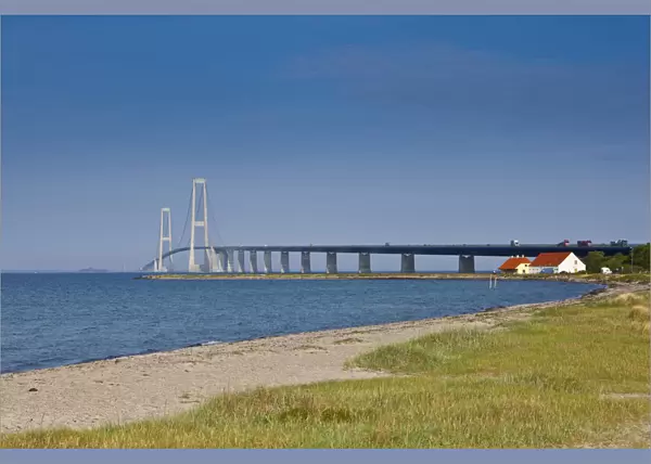 A white sand beach leads towards the East Bridge as seen from Korsor, Denmark