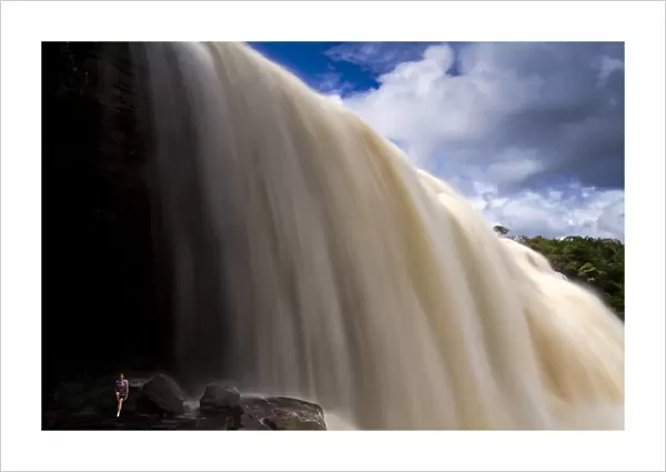 Venezuela, Guayana, Canaima National Park, Canaima, Tourist on rock looking at Sapo