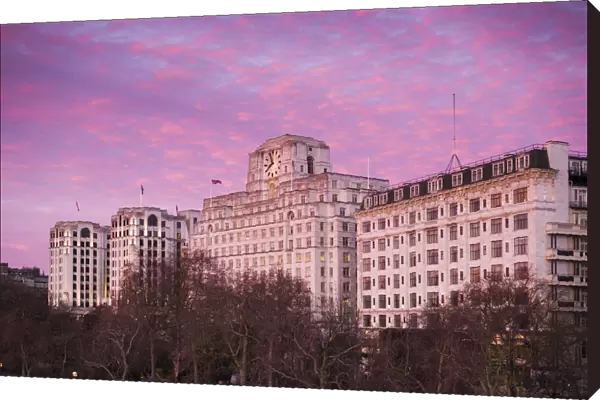 England, London, Victoria Embankment, buildings along Thames River, sunrise