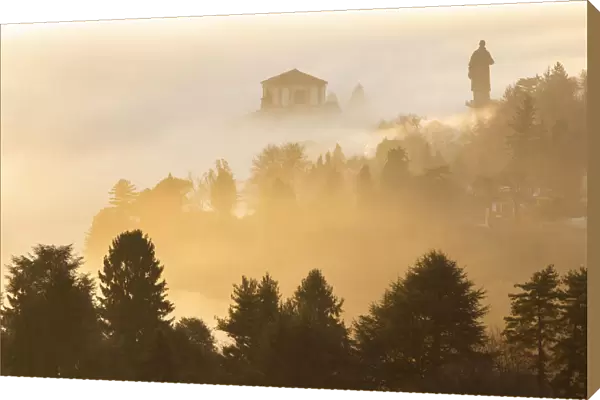 View of the Statue of San Carlo Borromeo in the morning winter fogs