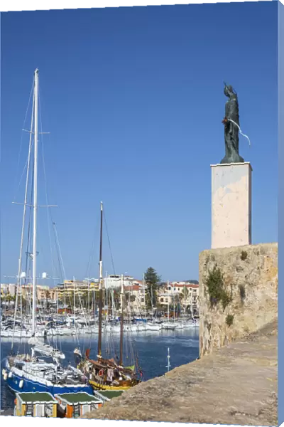 Italy, Sardinia, Alghero, View of harbour and St Elmo statue