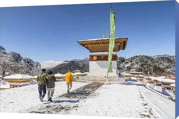 People walking amongst the 108 memorial chortens or stupas at Dochula Pass, Bhutan